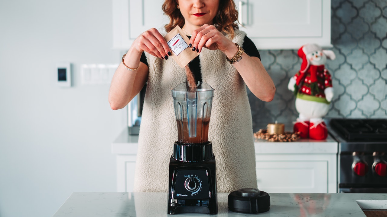 Woman using an electric blender