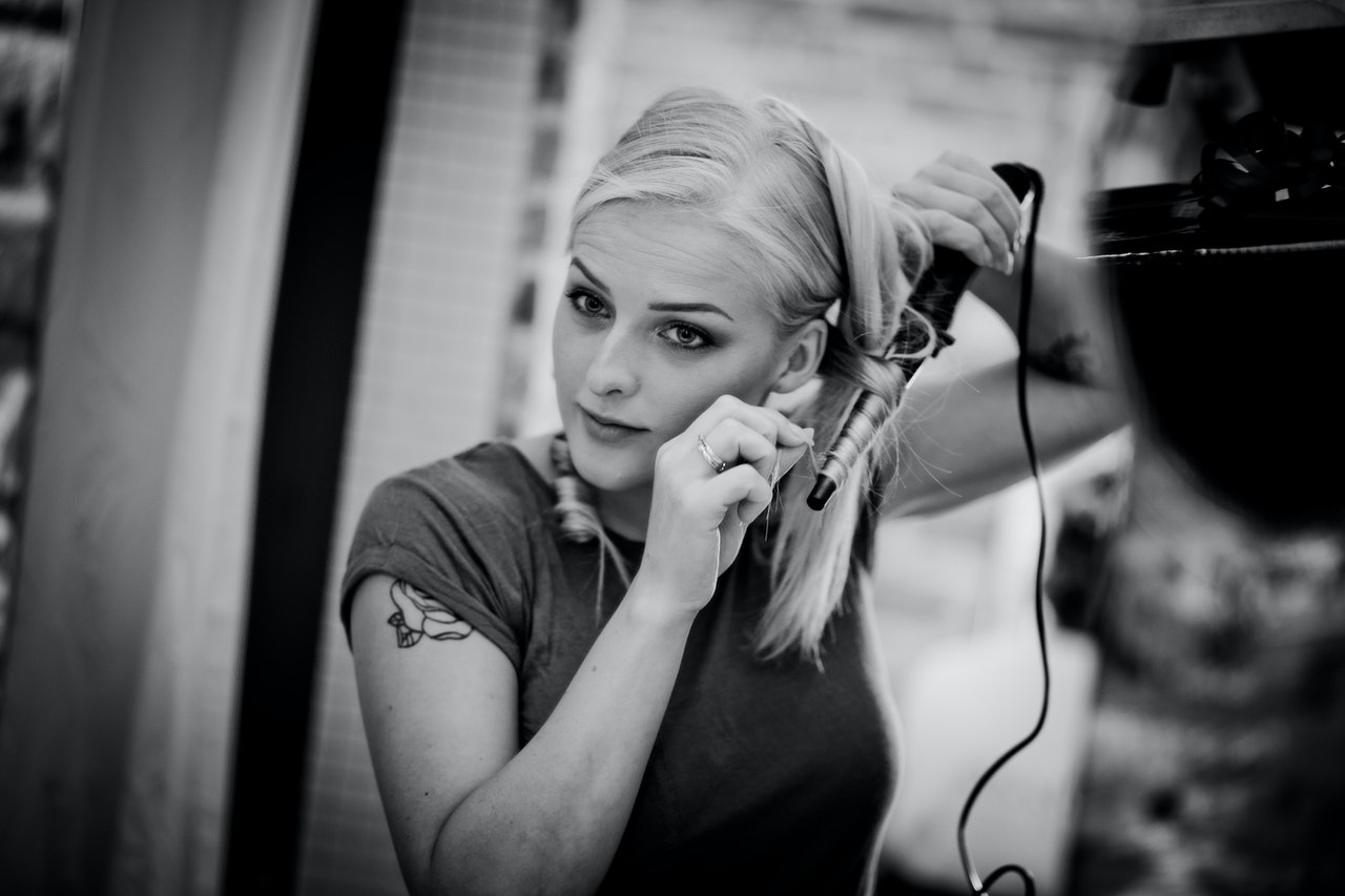 Woman using hair iron
